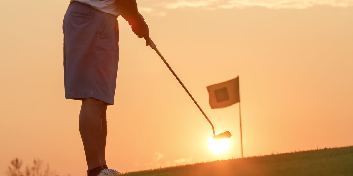 Golfer at sunset
